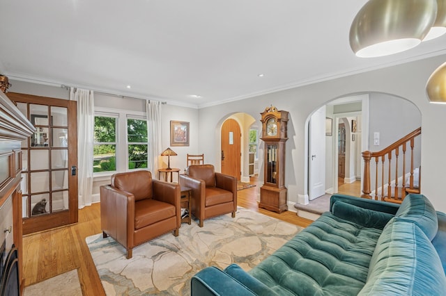 129 50th St, Minneapolis, MN 55419 - living area featuring arched walkways, light wood finished floors, stairway, crown molding, and recessed lighting