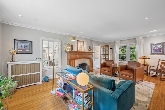 129 50th St, Minneapolis, MN 55419 - living area featuring light wood-style floors, a fireplace, radiator, crown molding, and recessed lighting