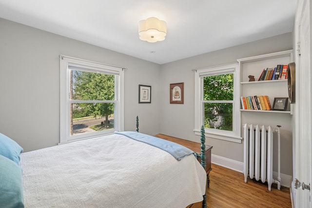 129 50th St, Minneapolis, MN 55419 - bedroom featuring radiator heating unit and wood finished floors