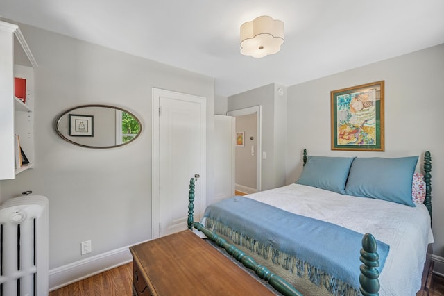 129 50th St, Minneapolis, MN 55419 - bedroom featuring radiator heating unit and wood finished floors