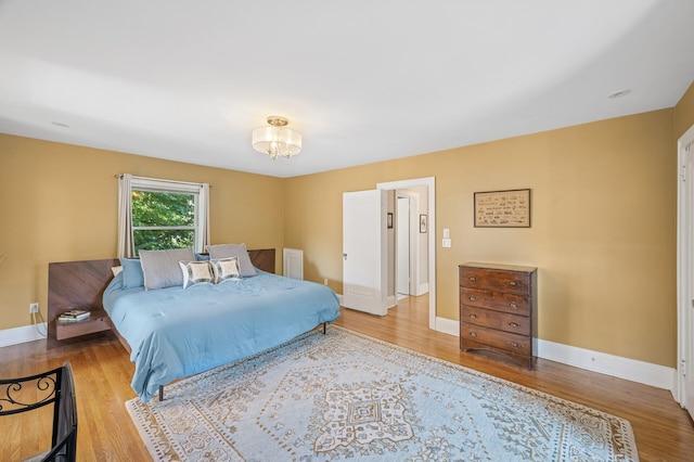 129 50th St, Minneapolis, MN 55419 - bedroom featuring wood finished floors and a chandelier