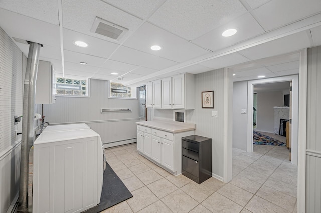 129 50th St, Minneapolis, MN 55419 - kitchen featuring a baseboard heating unit, light tile patterned flooring, white cabinetry, light countertops, and recessed lighting