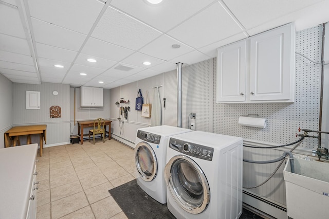 129 50th St, Minneapolis, MN 55419 - washroom featuring a baseboard radiator, washer and dryer, cabinet space, light tile patterned flooring, and recessed lighting