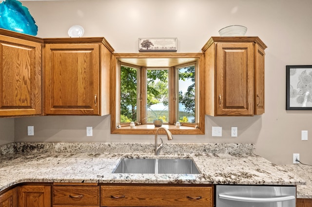 7023 State Highway 114 SW, Lake Mary Twp, MN 56308 - kitchen with stainless steel dishwasher, brown cabinets, and light stone countertops