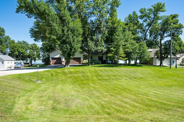 7023 State Highway 114 SW, Lake Mary Twp, MN 56308 - view of grassy yard featuring asphalt driveway and a garage