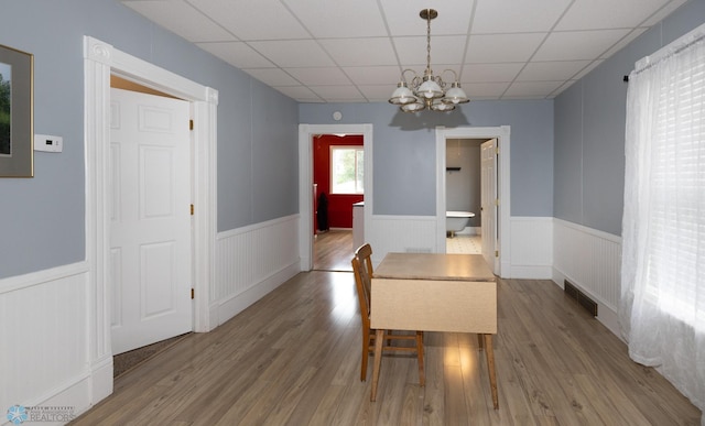 1341 3rd Ave N, Fargo, ND 58102 - dining room with wainscoting, a chandelier, a paneled ceiling, and wood finished floors