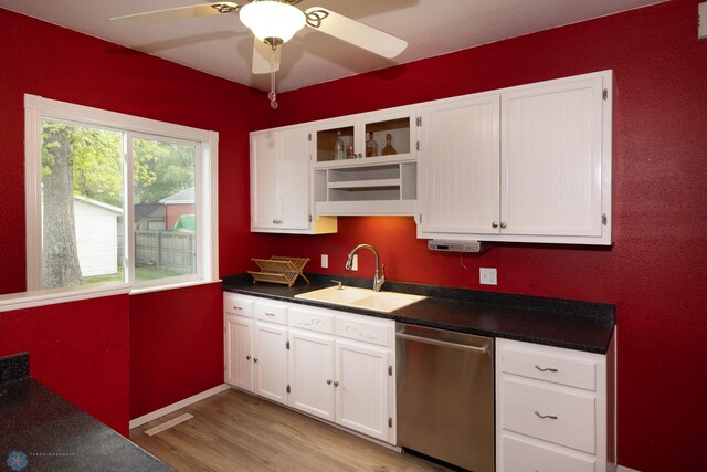 1341 3rd Ave N, Fargo, ND 58102 - kitchen featuring dishwasher, dark countertops, white cabinetry, light wood-style flooring, and ceiling fan