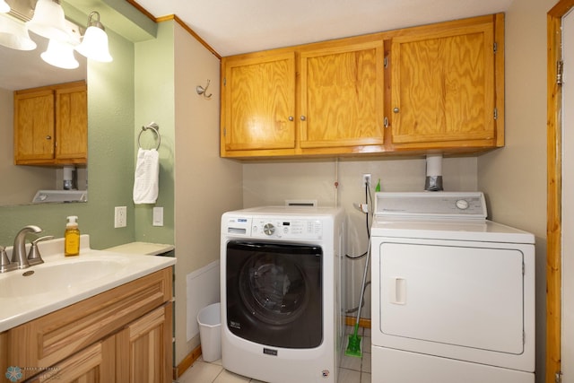 1341 3rd Ave N, Fargo, ND 58102 - washroom with independent washer and dryer, cabinet space, and light tile patterned flooring