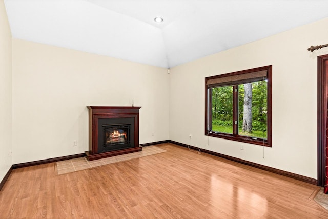 5110 Foxborrow Dr, Hermantown, MN 55811 - unfurnished living room with light wood finished floors, a glass covered fireplace, and vaulted ceiling