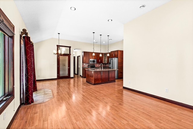 5110 Foxborrow Dr, Hermantown, MN 55811 - kitchen featuring appliances with stainless steel finishes, light wood-style floors, a chandelier, an island with sink, and decorative light fixtures