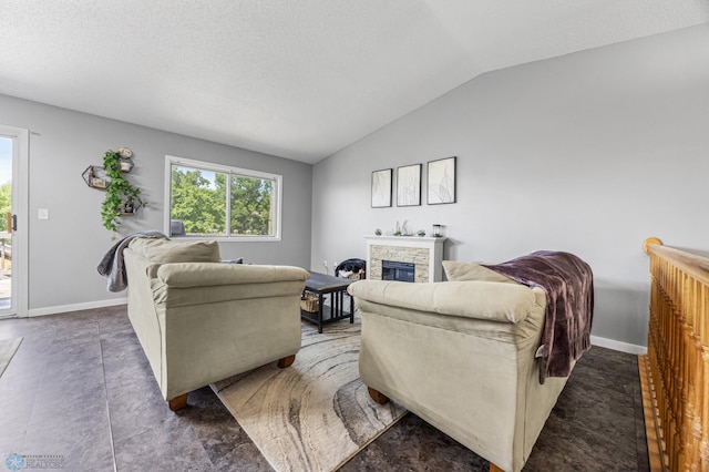 1030 Oak Pl, West Fargo, ND 58078 - living area with vaulted ceiling, a fireplace, and a textured ceiling