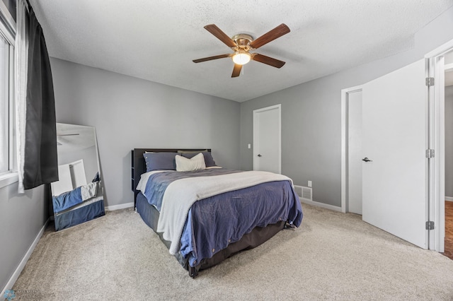 1030 Oak Pl, West Fargo, ND 58078 - bedroom with carpet floors, ceiling fan, and a textured ceiling