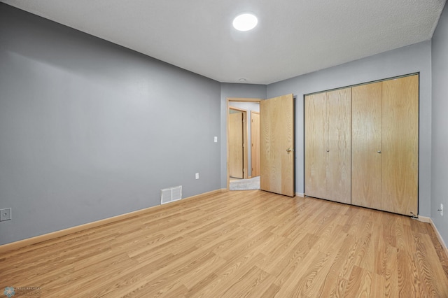 1030 Oak Pl, West Fargo, ND 58078 - unfurnished bedroom featuring wood finished floors and a closet
