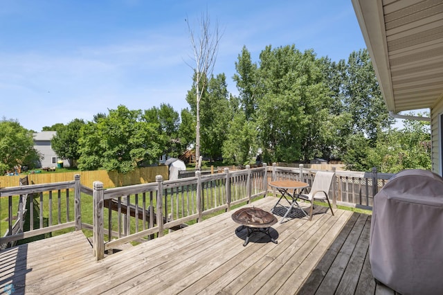 1030 Oak Pl, West Fargo, ND 58078 - wooden terrace featuring a fire pit, grilling area, a fenced backyard, and a storage shed