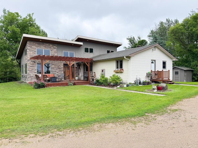 23336 County Highway 120, Fergus Falls, MN 56537 - view of front of home with a pergola, a wooden deck, a front yard, and stone siding