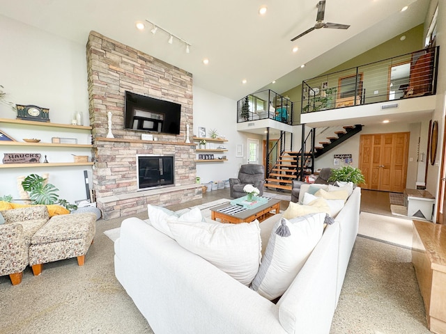 23336 County Highway 120, Fergus Falls, MN 56537 - living area with stairs, a ceiling fan, high vaulted ceiling, a stone fireplace, and track lighting
