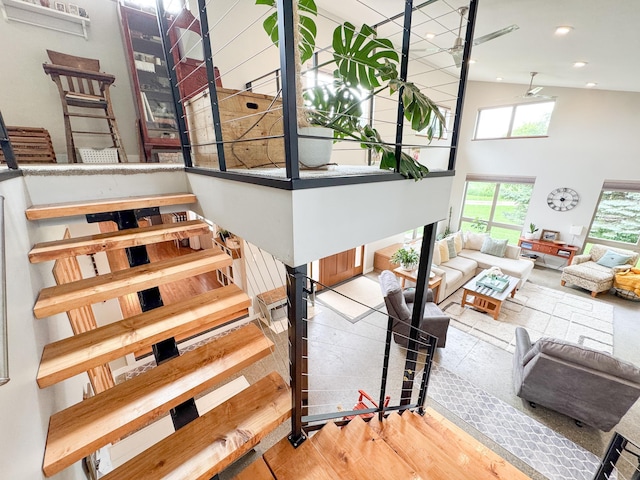 23336 County Highway 120, Fergus Falls, MN 56537 - stairway featuring a high ceiling, wood finished floors, and recessed lighting