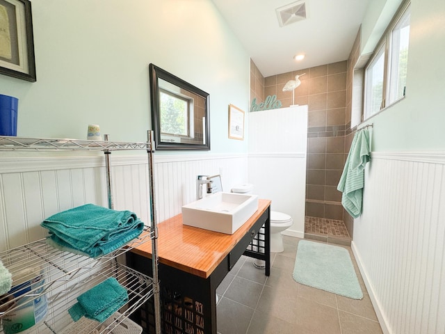 23336 County Highway 120, Fergus Falls, MN 56537 - full bathroom featuring a walk in shower, wainscoting, tile patterned flooring, and vanity