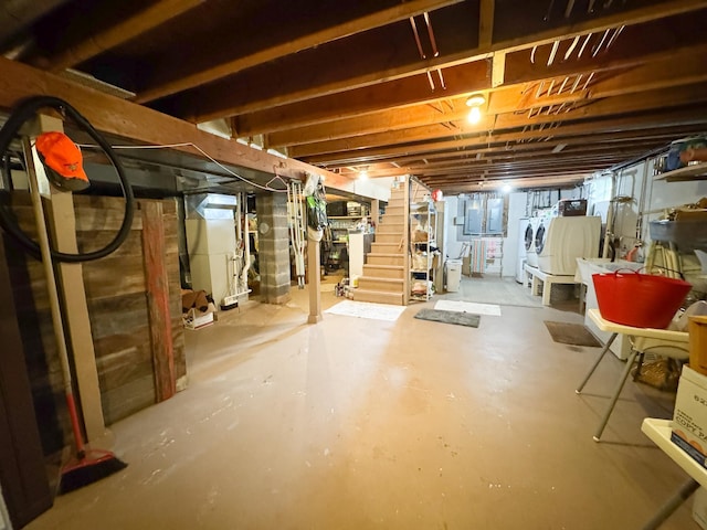 23336 County Highway 120, Fergus Falls, MN 56537 - unfinished basement featuring washing machine and clothes dryer, stairs, water heater, and heating unit