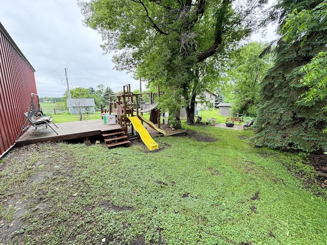 23336 County Highway 120, Fergus Falls, MN 56537 - view of green lawn with a playground and a wooden deck