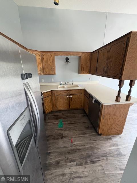 421 Dorland Rd S, Maplewood, MN 55119 - kitchen featuring appliances with stainless steel finishes, dark wood-style flooring, light countertops, brown cabinetry, and a peninsula