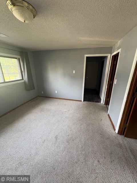 421 Dorland Rd S, Maplewood, MN 55119 - carpeted empty room with a textured ceiling and baseboards
