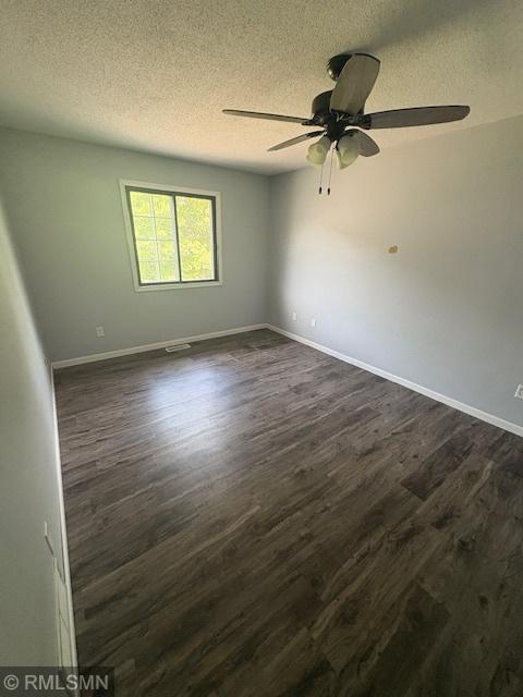 421 Dorland Rd S, Maplewood, MN 55119 - spare room with dark wood finished floors, a textured ceiling, and ceiling fan