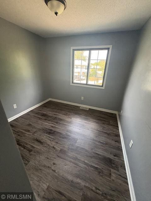 421 Dorland Rd S, Maplewood, MN 55119 - unfurnished room featuring a textured ceiling and dark wood-style floors