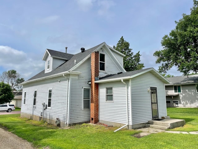 212 Sanborn St, Springfield, MN 56087 - rear view of house with a lawn and roof with shingles