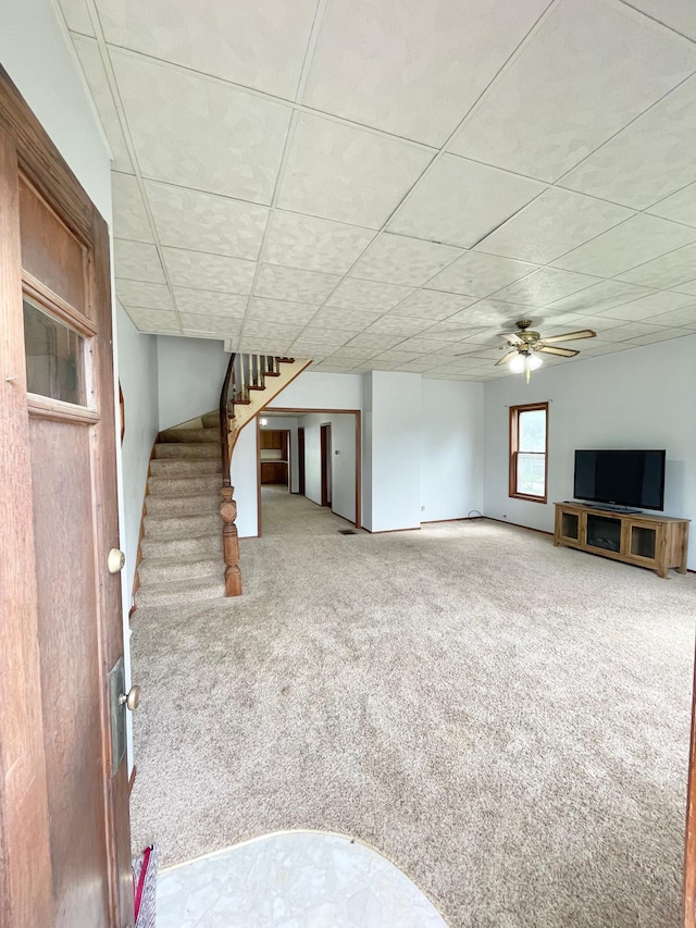 212 Sanborn St, Springfield, MN 56087 - unfurnished living room with carpet floors, stairs, and a ceiling fan