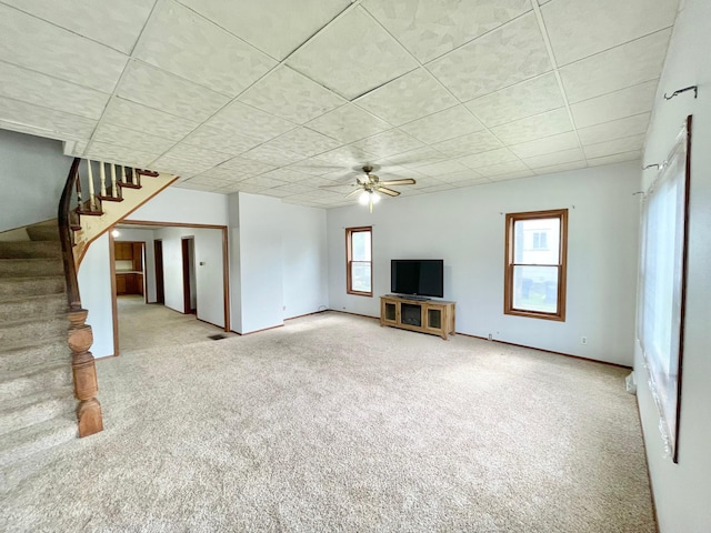 212 Sanborn St, Springfield, MN 56087 - unfurnished living room featuring carpet flooring, healthy amount of natural light, stairs, and a ceiling fan