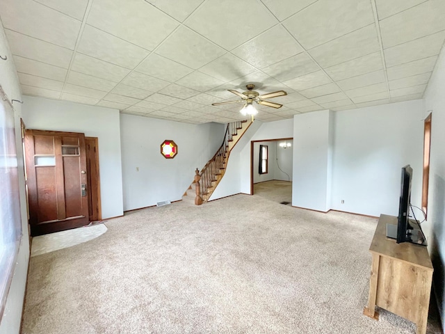 212 Sanborn St, Springfield, MN 56087 - unfurnished living room featuring carpet floors, stairway, a drop ceiling, and ceiling fan