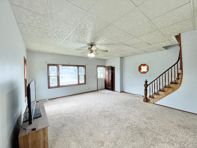 212 Sanborn St, Springfield, MN 56087 - unfurnished living room with carpet floors, stairs, a ceiling fan, and a drop ceiling