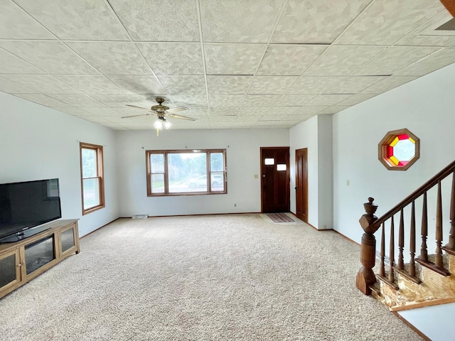 212 Sanborn St, Springfield, MN 56087 - unfurnished living room featuring carpet, healthy amount of natural light, ceiling fan, and stairway
