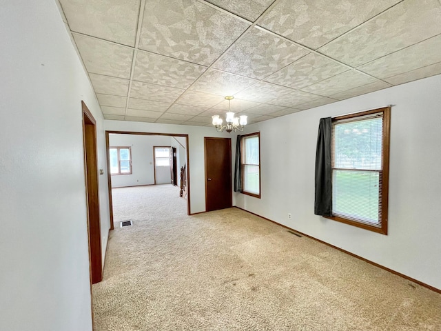 212 Sanborn St, Springfield, MN 56087 - empty room featuring carpet, a chandelier, and a drop ceiling