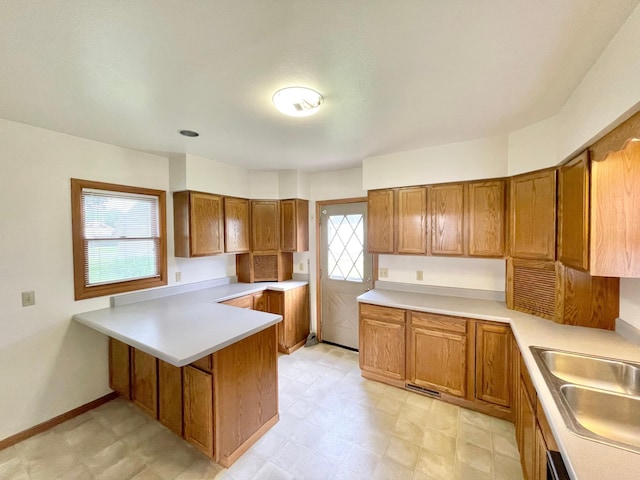 212 Sanborn St, Springfield, MN 56087 - kitchen with brown cabinets, a peninsula, and healthy amount of natural light