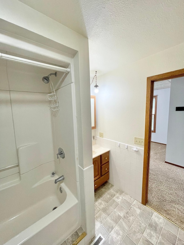 212 Sanborn St, Springfield, MN 56087 - bathroom featuring shower / bath combination, vanity, tile walls, and a textured ceiling
