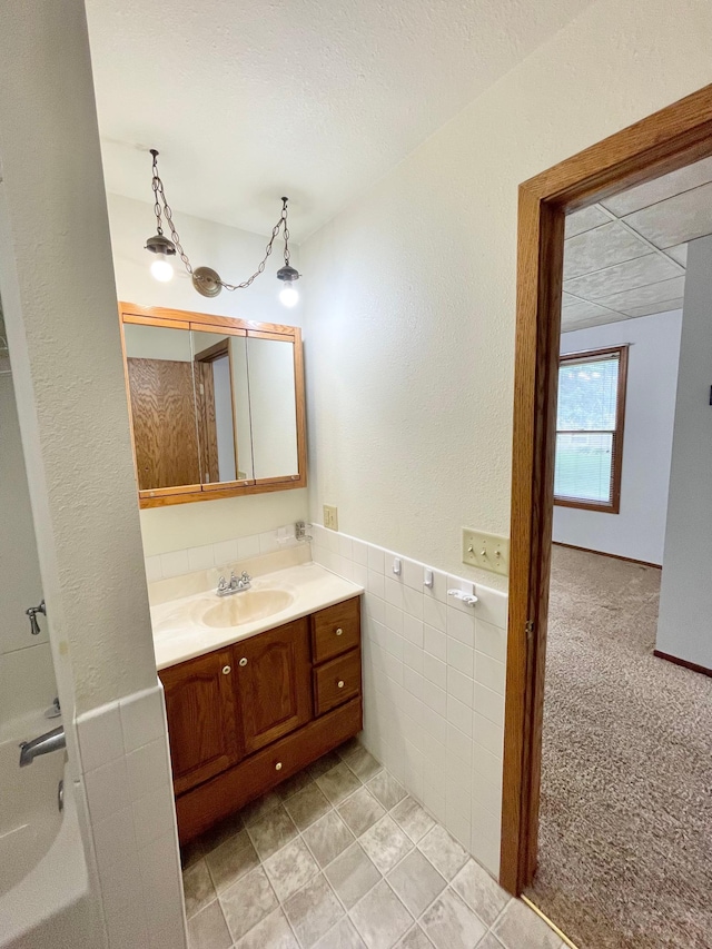 212 Sanborn St, Springfield, MN 56087 - bathroom featuring vanity, tile walls, a textured ceiling, and a textured wall