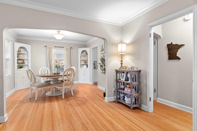 1921 James Ave, Saint Paul, MN 55105 - dining room with arched walkways, light wood-type flooring, and ornamental molding