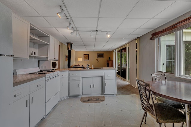 20404 Elkview Rd, Munson Twp, MN 56368 - kitchen with track lighting, white appliances, open shelves, a peninsula, and white cabinetry
