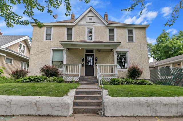 893 Jenks Ave, Saint Paul, MN 55106 - view of front of house with stucco siding, a porch, and a chimney