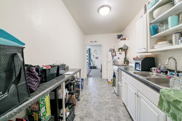893 Jenks Ave, Saint Paul, MN 55106 - kitchen featuring gas range gas stove, tasteful backsplash, white cabinets, open shelves, and stone finish flooring