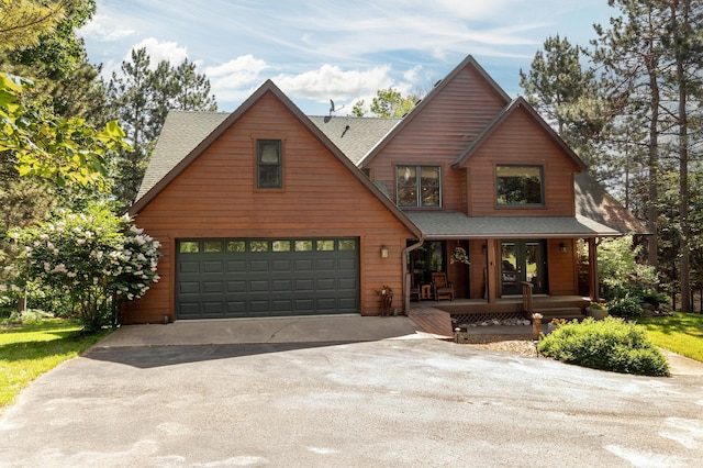 49760 202nd Pl, Mcgregor, MN 55760 - chalet / cabin with a porch, driveway, a garage, and a shingled roof
