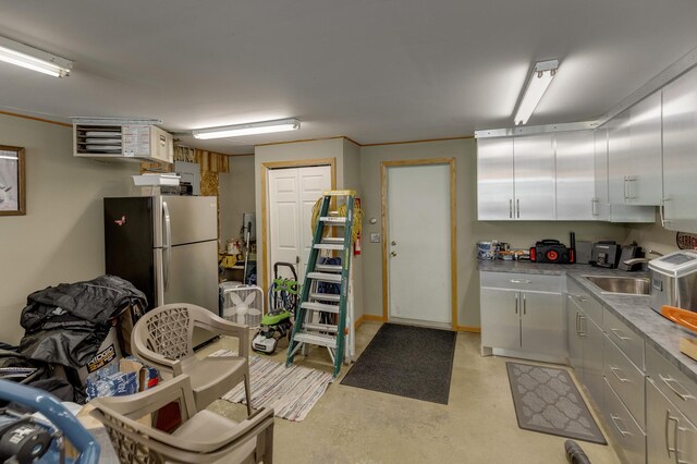 49760 202nd Pl, Mcgregor, MN 55760 - kitchen with freestanding refrigerator, finished concrete floors, a heating unit, and light countertops