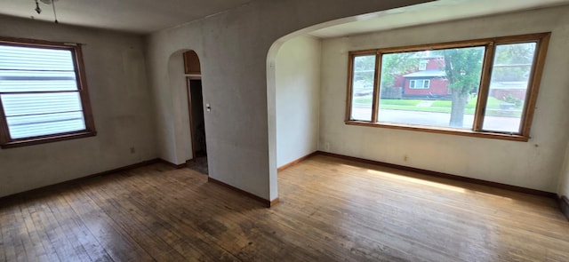 922 White St, Jackson, MN 56143 - empty room featuring arched walkways and hardwood / wood-style flooring
