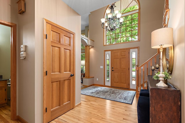 842 Vista Cir, Delano, MN 55328 - foyer entrance with light wood-type flooring, a chandelier, a towering ceiling, and stairway