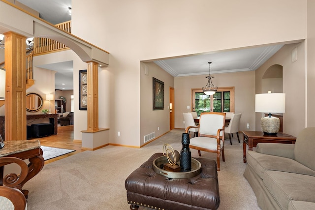 842 Vista Cir, Delano, MN 55328 - living room with decorative columns, arched walkways, light colored carpet, and crown molding