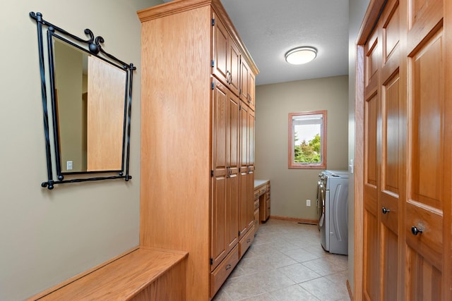 842 Vista Cir, Delano, MN 55328 - laundry room featuring light tile patterned flooring, washing machine and dryer, and cabinet space