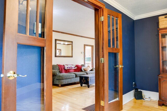 914 9th Ave N, Saint Cloud, MN 56303 - hallway with wood finished floors, crown molding, and french doors