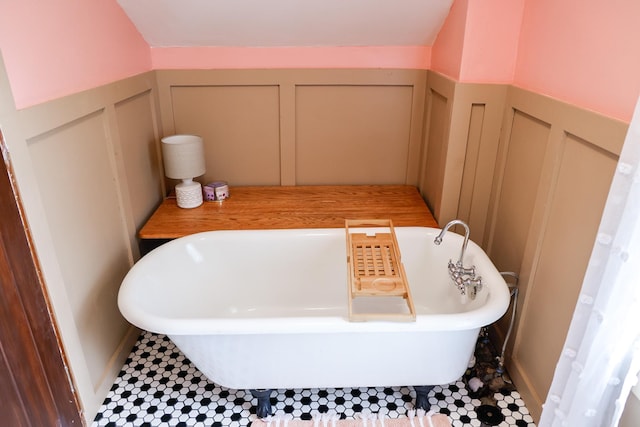 914 9th Ave N, Saint Cloud, MN 56303 - bathroom featuring a decorative wall, a freestanding tub, and wainscoting